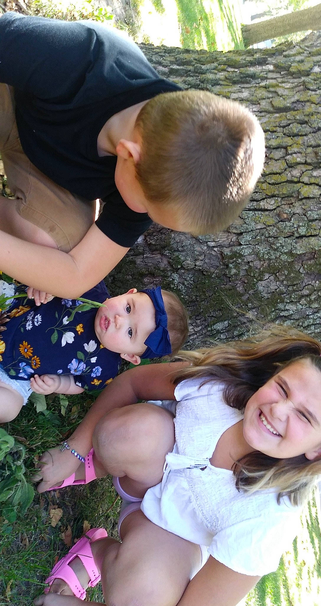 Kiley is registered to the contest to win money with this photo: arm, clothing, dress, facial_expression, gesture, grass, hairstyle, hand, happy, headwear, human, human_body, interaction, joy, leg, organ, people_in_nature, person, photograph, plant