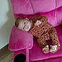 Serenity is registered to the contest to win money with this photo: baby, child, infant, sofa, pink_sofa, plush_furniture, leopard_print_clothing, footed_pajamas, indoor, wood_floor, face, person, relaxing, couch, home_interior, cozy, seated, looking_at_camera, cute, child_clothing