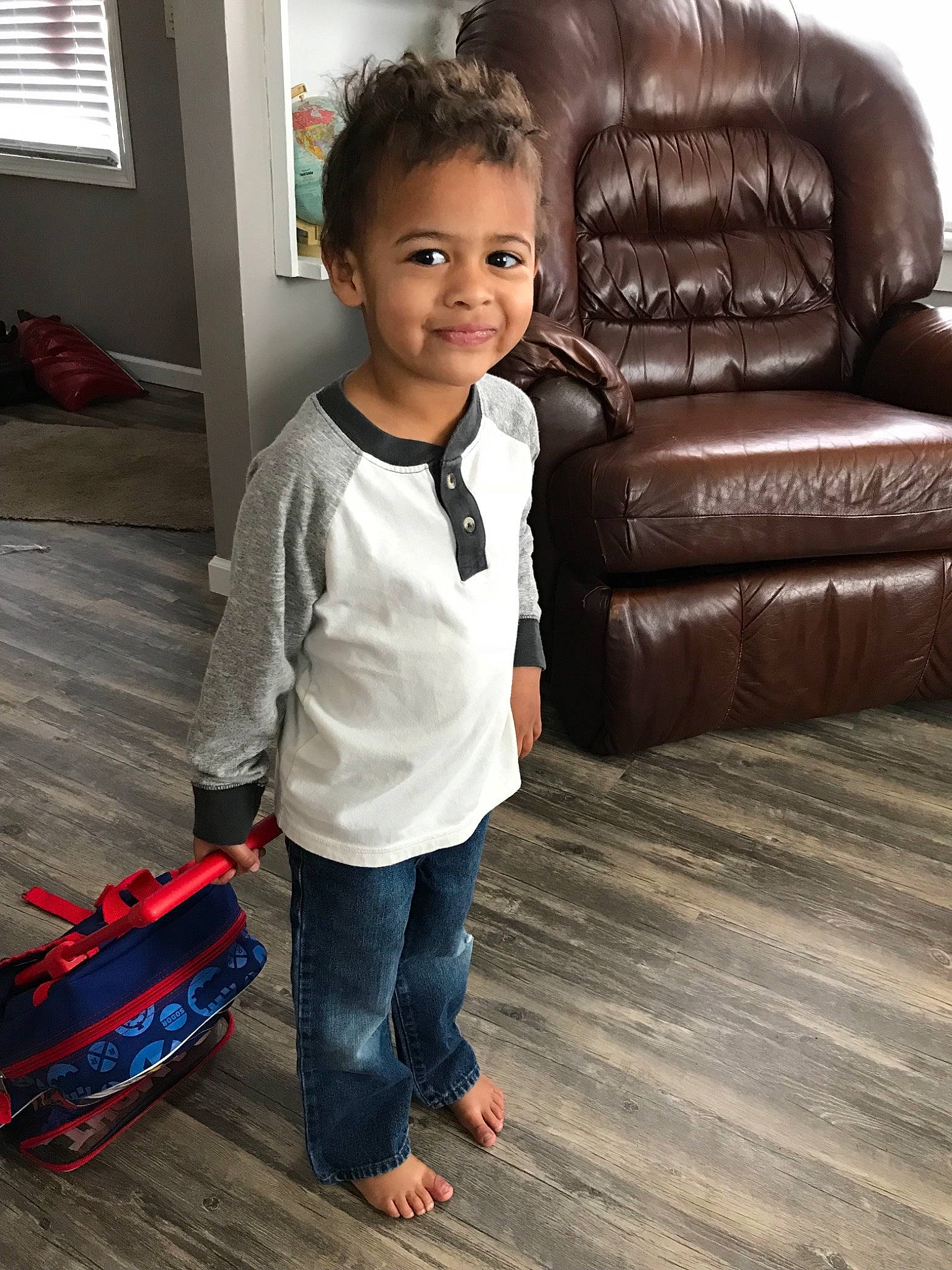 Micah joined the competition — help win amazing prizes! child, child_model, floor, flooring, footwear, furniture, hardwood, jeans, leg, outerwear, person, play, shoe, sitting, skin, sleeve, smile, standing, toddler, wood