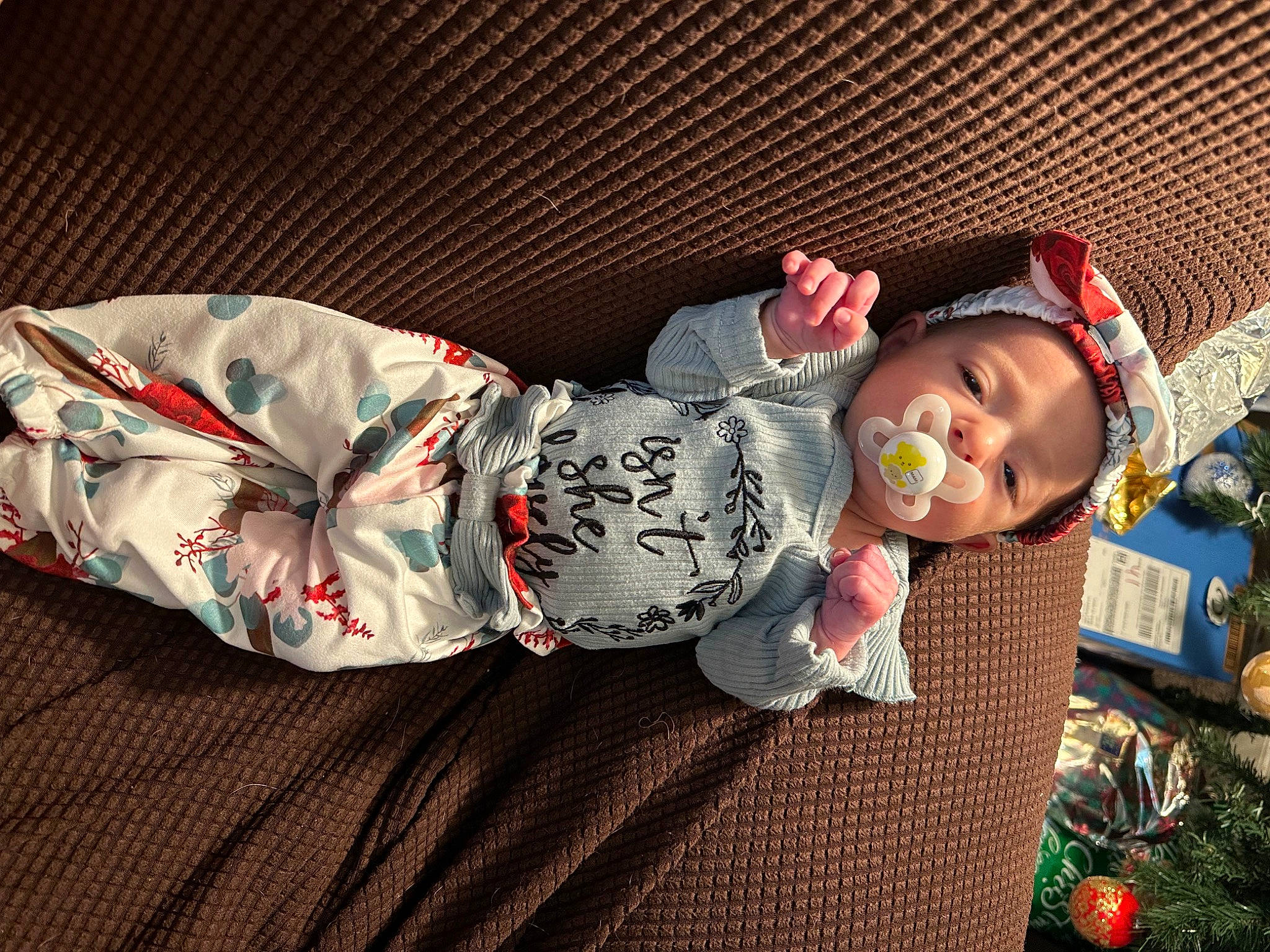 Autumn is registered to the contest to win money with this photo: baby, baby_products, baby_toddler_clothing, child, comfort, event, linens, pattern, person, plant, room, sitting, sleeve, toddler, tree