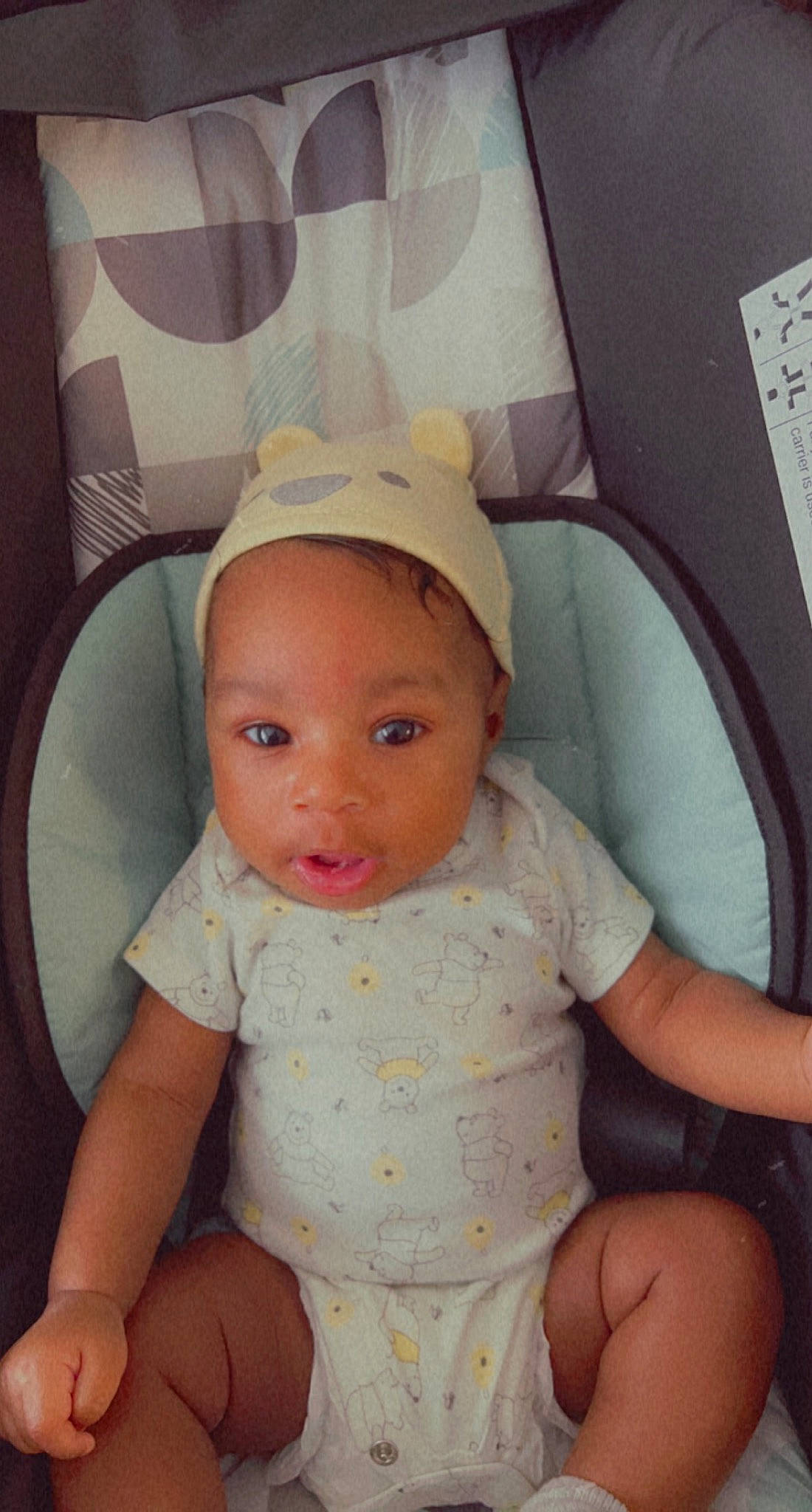 Nasir joined the competition — help win amazing prizes! baby, baby_toddler_clothing, baseball_cap, cap, cheek, child, chin, comfort, eyelash, finger, fun, iris, lip, mouth, nose, person, product, sitting, skin, sleeve