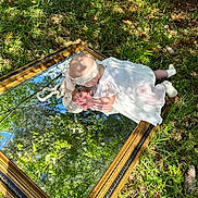 Oaklynn joined the competition — help win amazing prizes! baby, clothing, dress, face, garden, grass, hat, head, land, leaf, nature, outdoors, park, person, photography, plant, portrait, tree, vegetation, woodland