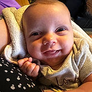 Rylinn joined the competition — help win amazing prizes! baby, blanket, child, close_up, clothing, couch, cozy, cute, expression, face, hand, happy, indoor, infant, person, portrait, skin, smiling, towel, young