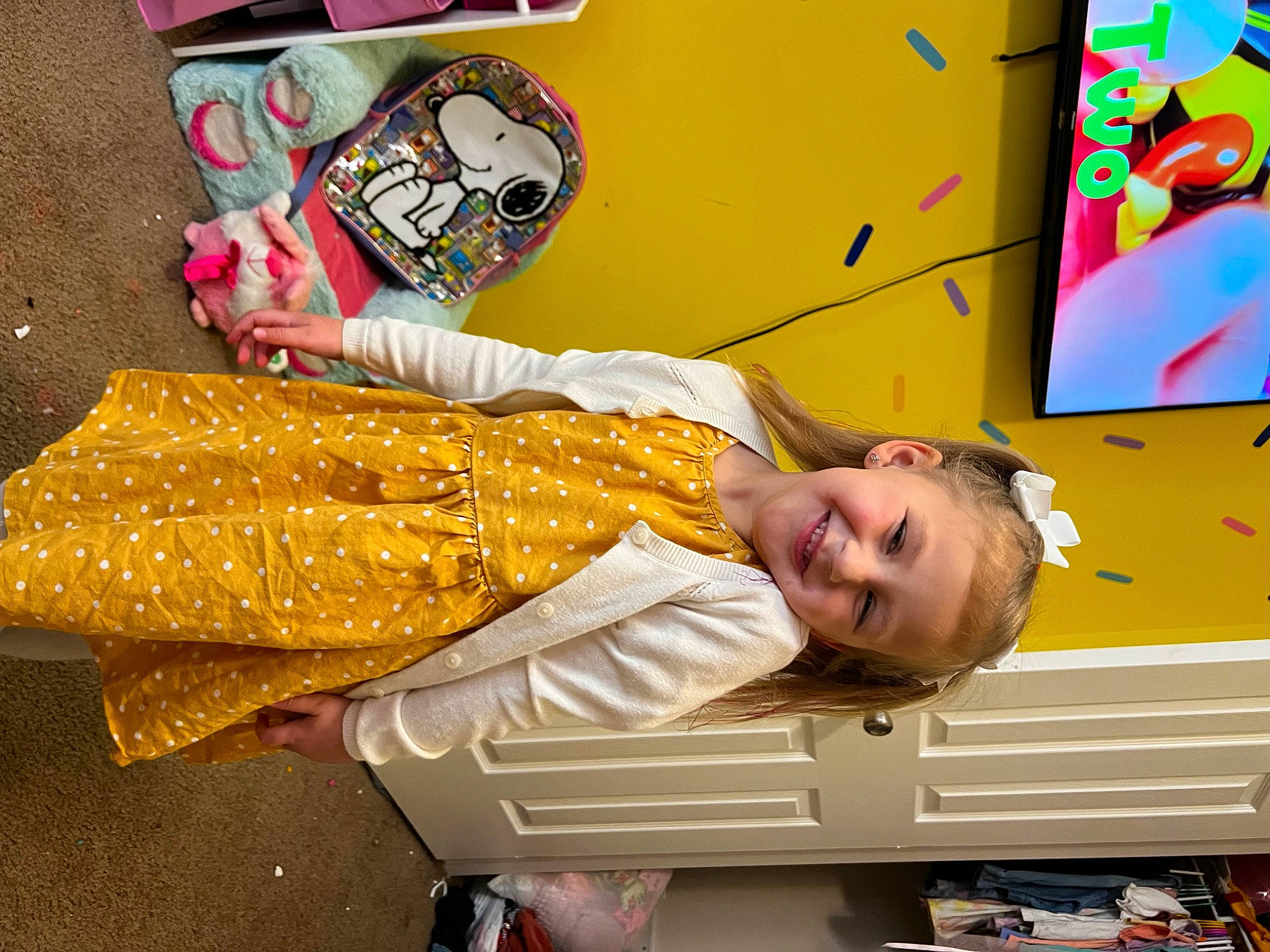 Ava is registered to the contest to win money with this photo: advertising, art, child, event, fun, happy, joy, leisure, person, recreation, room, smile, toddler, travel, visual_arts, yellow