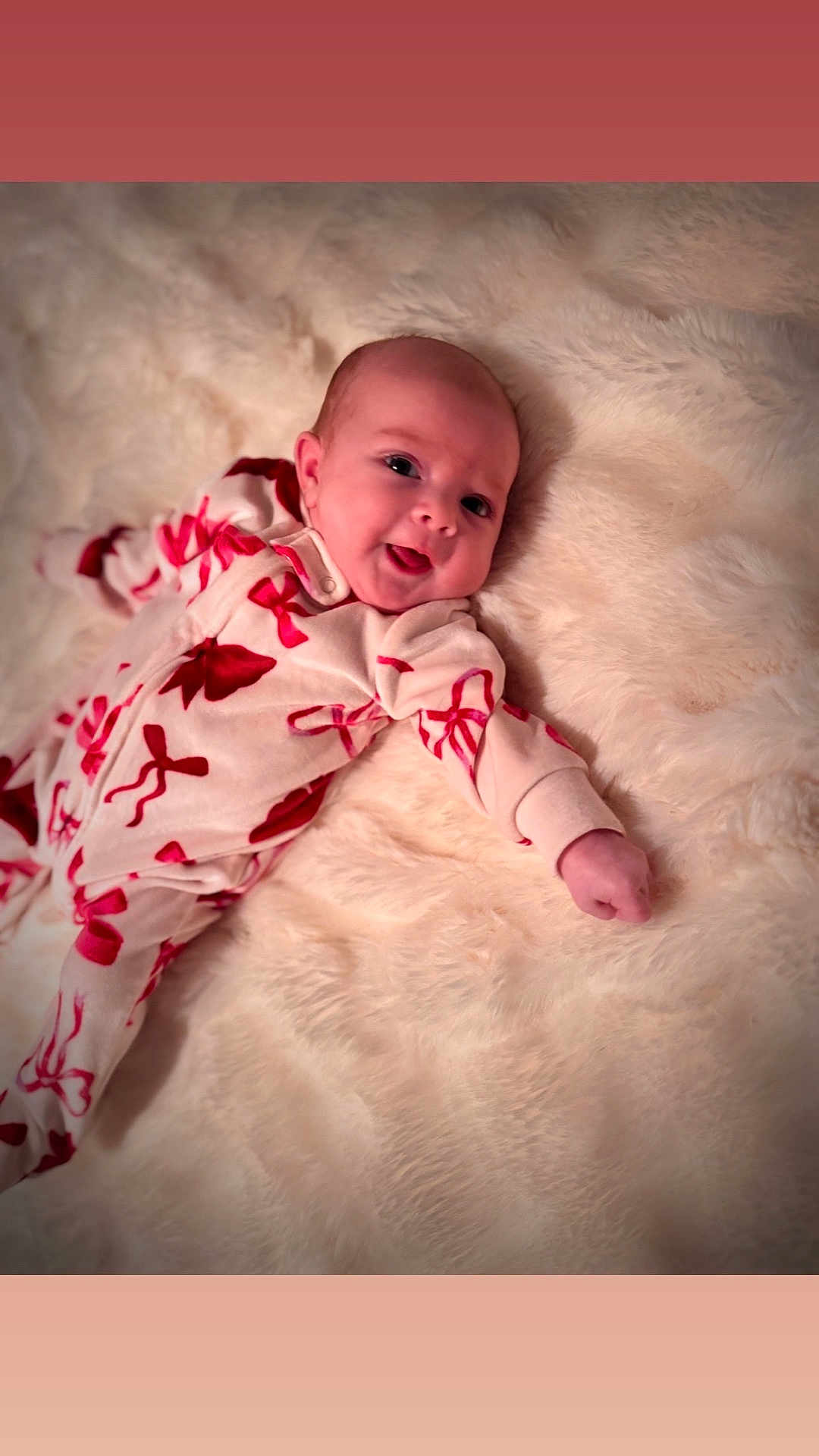 Olivia joined the competition — help win amazing prizes! baby, infant, smile, face, onesie, red_bows, blanket, soft_texture, lying_down, cute, happy, child, cozy, indoors, portrait, skin, head, hand, expression, newborn