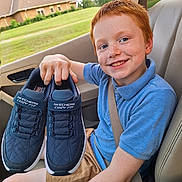 Truman joined the competition — help win amazing prizes! child, boy, red_hair, freckles, blue_polo_shirt, tan_shorts, car_seat, seatbelt, shoes, skechers, smiling, happy, hand, car_interior, window, green_lawn, house, wristbands, casual_clothing, portrait