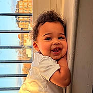 Grayson joined the competition — help win amazing prizes! toddler, child, smiling, curly_hair, white_shirt, window, sunlight, indoor, face, happy, cute, portrait, baby, cheerful, young_child, skin, expression, person, daylight, home