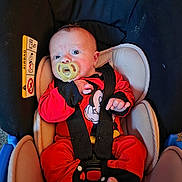 Frankie joined the competition — help win amazing prizes! baby, car_seat, pacifier, red_clothing, mickey_mouse, infant, child, seatbelt, straps, foot, hand, face, cute, indoors, young_child, sitting, safety, car, child_safety_seat, closeup