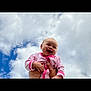 Maizey is registered to the contest to win money with this photo: baby, child, infant, smiling, happy, pink_clothing, outdoor, sky, clouds, hands, cute, joyful, portrait, person, young, playful, holding, bright, daylight, fun