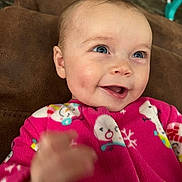 Maizey joined the competition — help win amazing prizes! baby, child, smile, blue_eyes, pink_onesie, snowman_pattern, hand, face, happy, infant, cozy, cute, portrait, indoors, soft_background, candid, expression, skin, person, warm