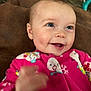 baby, child, smile, blue_eyes, pink_onesie, snowman_pattern, hand, face, happy, infant, cozy, cute, portrait, indoors, soft_background, candid, expression, skin, person, warm