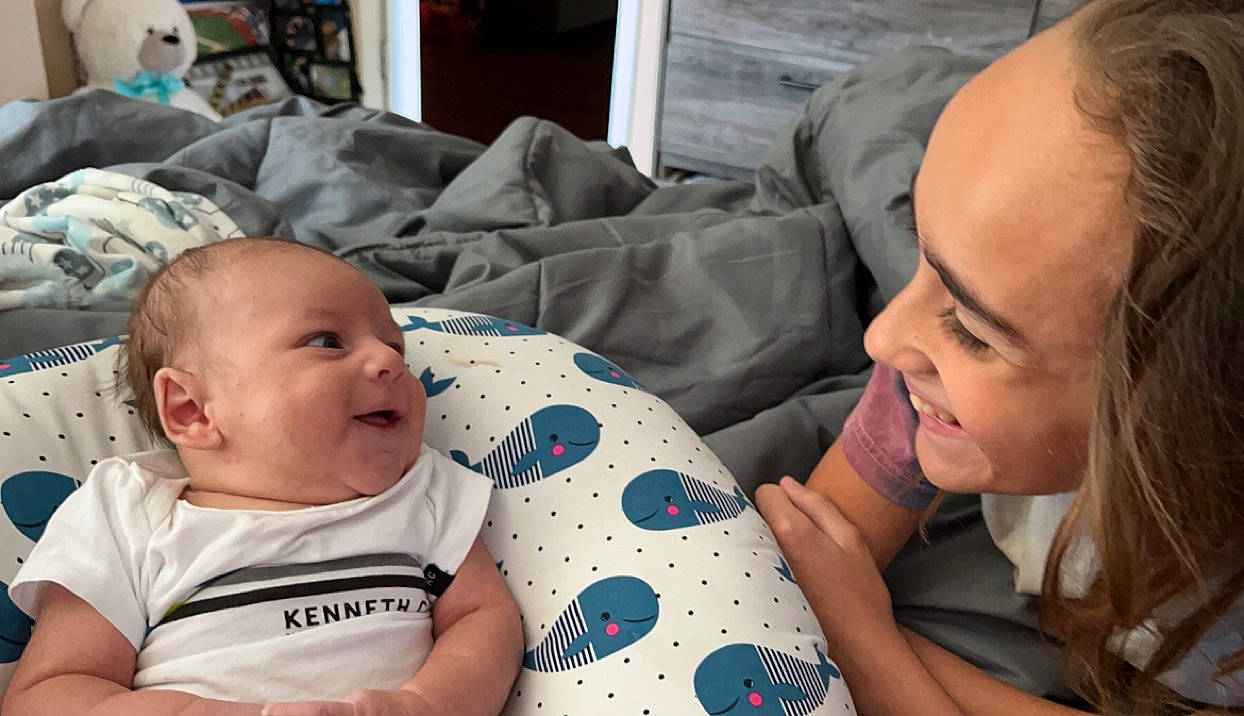 Cameron is registered to the contest to win money with this photo: baby, baby_toddler_clothing, cheek, child, comfort, event, eye, eyebrow, fun, grass, happy, iris, mouth, nose, person, sitting, skin, smile, t_shirt, toddler