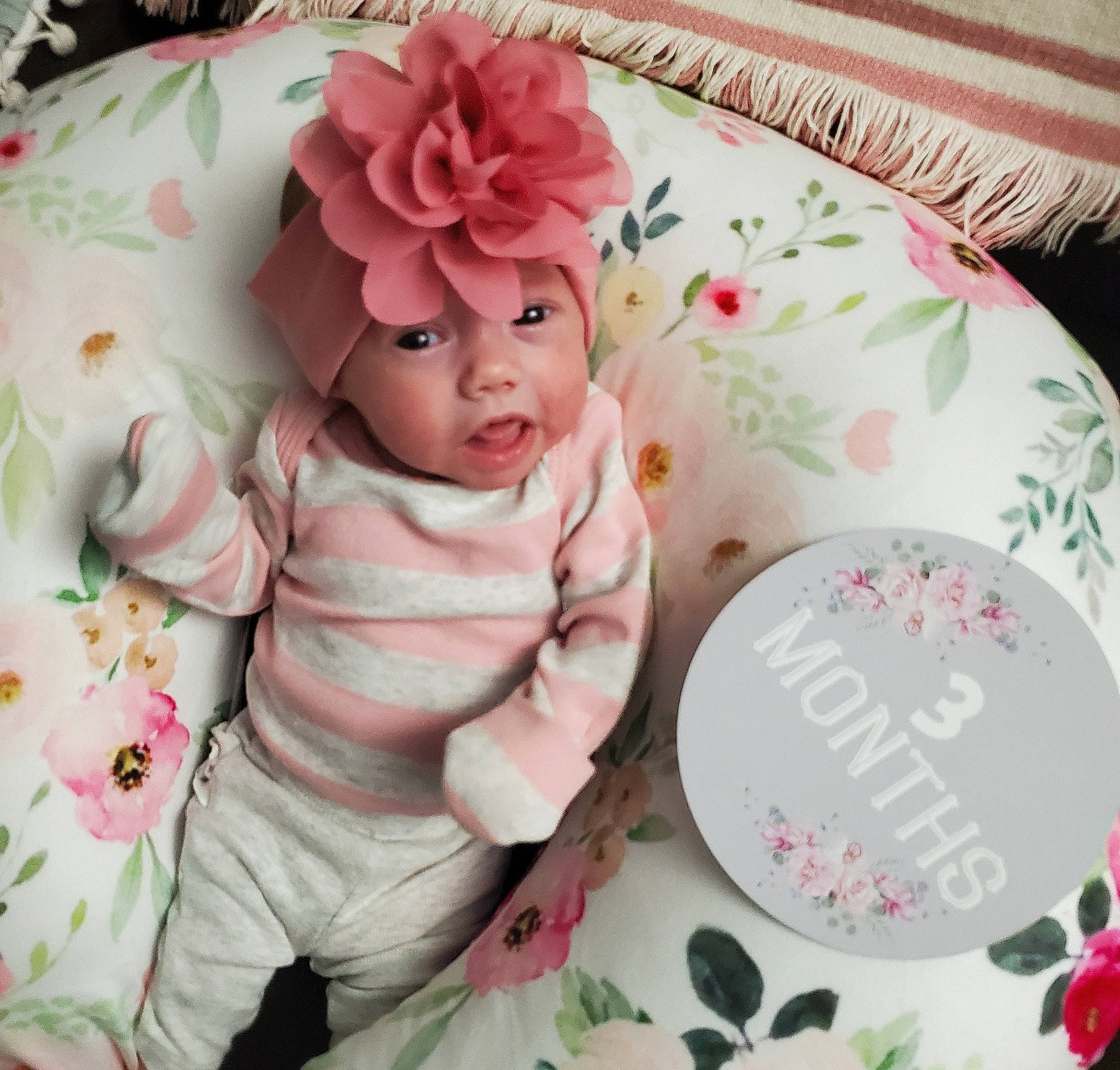 Lydia joined the competition — help win amazing prizes! baby, baby_toddler_clothing, bedding, child, comfort, cut_flowers, dishware, fashion_accessory, flower, font, headwear, linens, magenta, pattern, peach, person, petal, pink, rose, sleeve