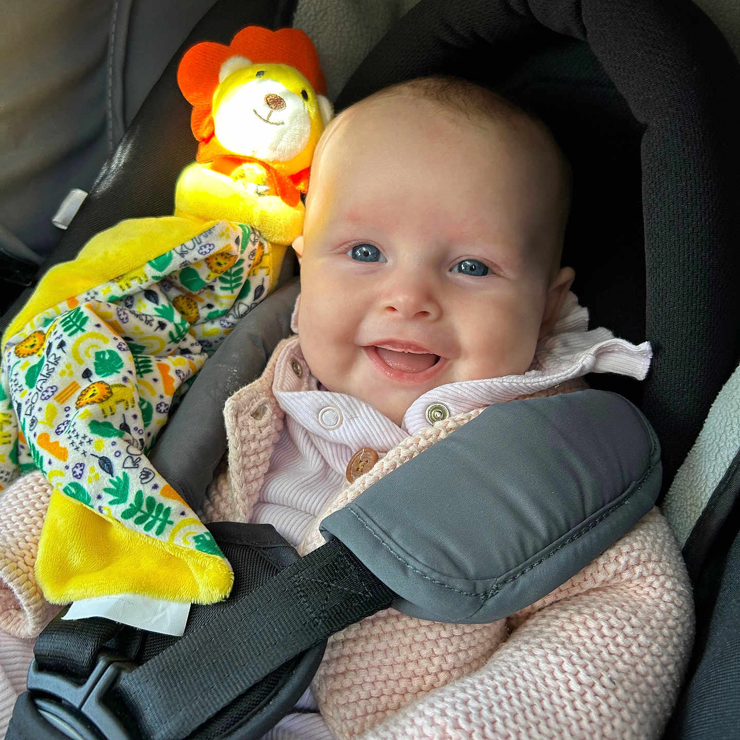 Keira is registered to the contest to win money with this photo: baby, car, clothing, coat, crib, cushion, face, furniture, happy, head, homedecor, infantbed, jacket, person, photography, portrait, smile, toy, transportation, vehicle