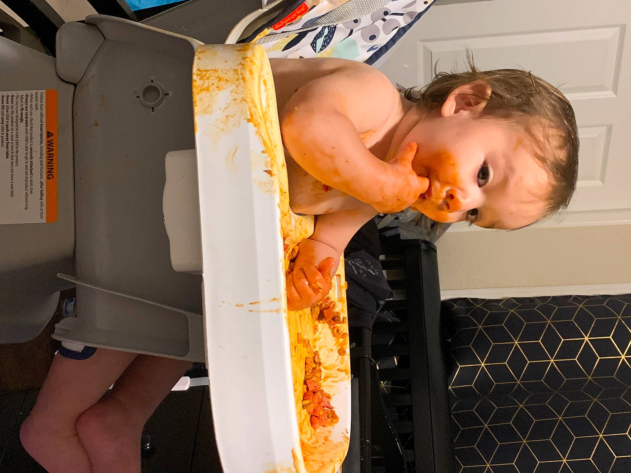 Lucian is registered to the contest to win money with this photo: abdomen, baby, barechested, chest, child, elbow, flooring, fun, human_leg, joint, knee, leg, orange, person, personal_protective_equipment, room, shoulder, thigh, toddler, trunk