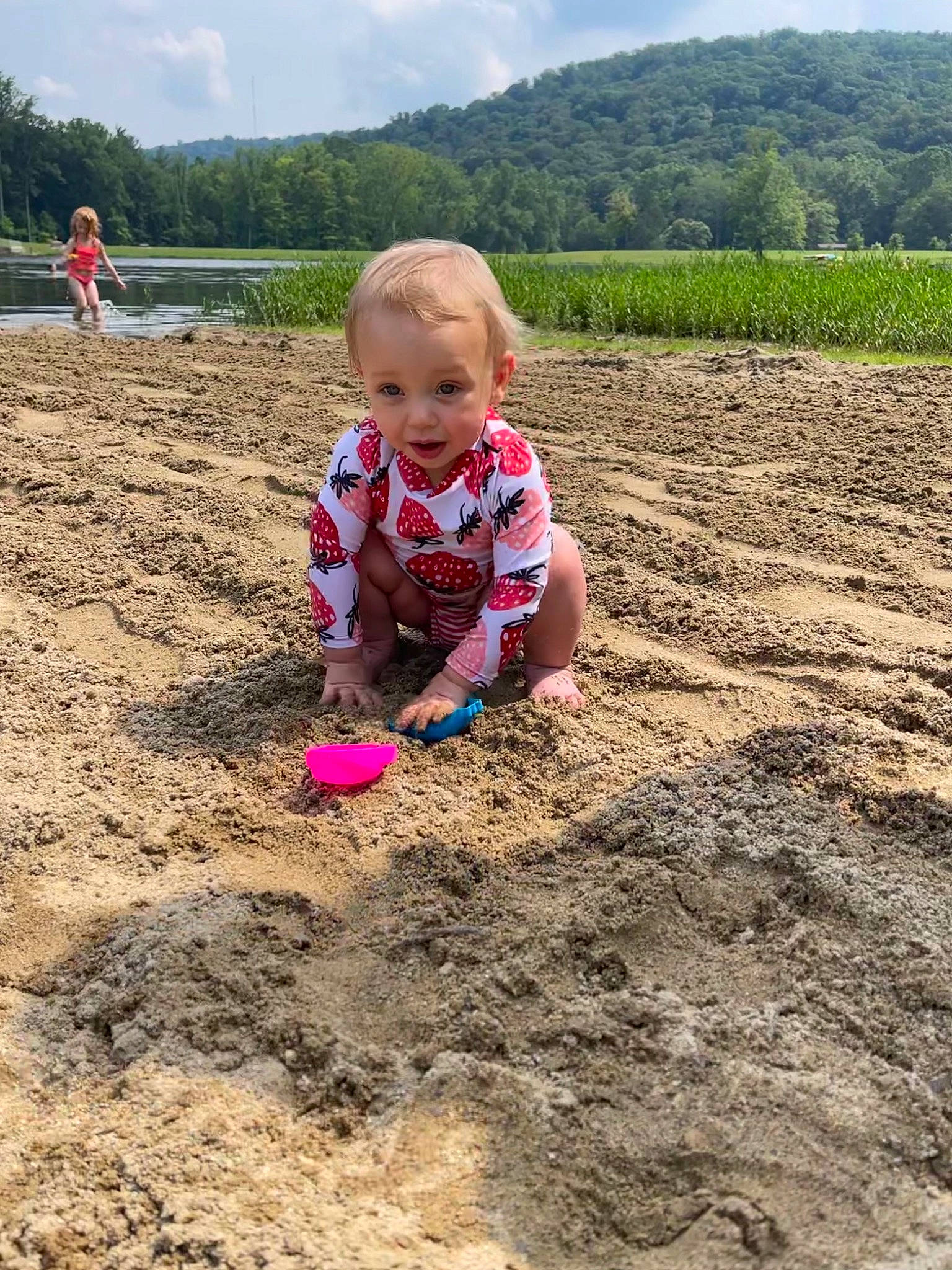 Linda joined the competition — help win amazing prizes! agriculture, baby, child, cloud, field, fun, grass, green, happy, landscape, mountain, natural_environment, people_in_nature, person, plant, sand, sky, smile, soil, toddler