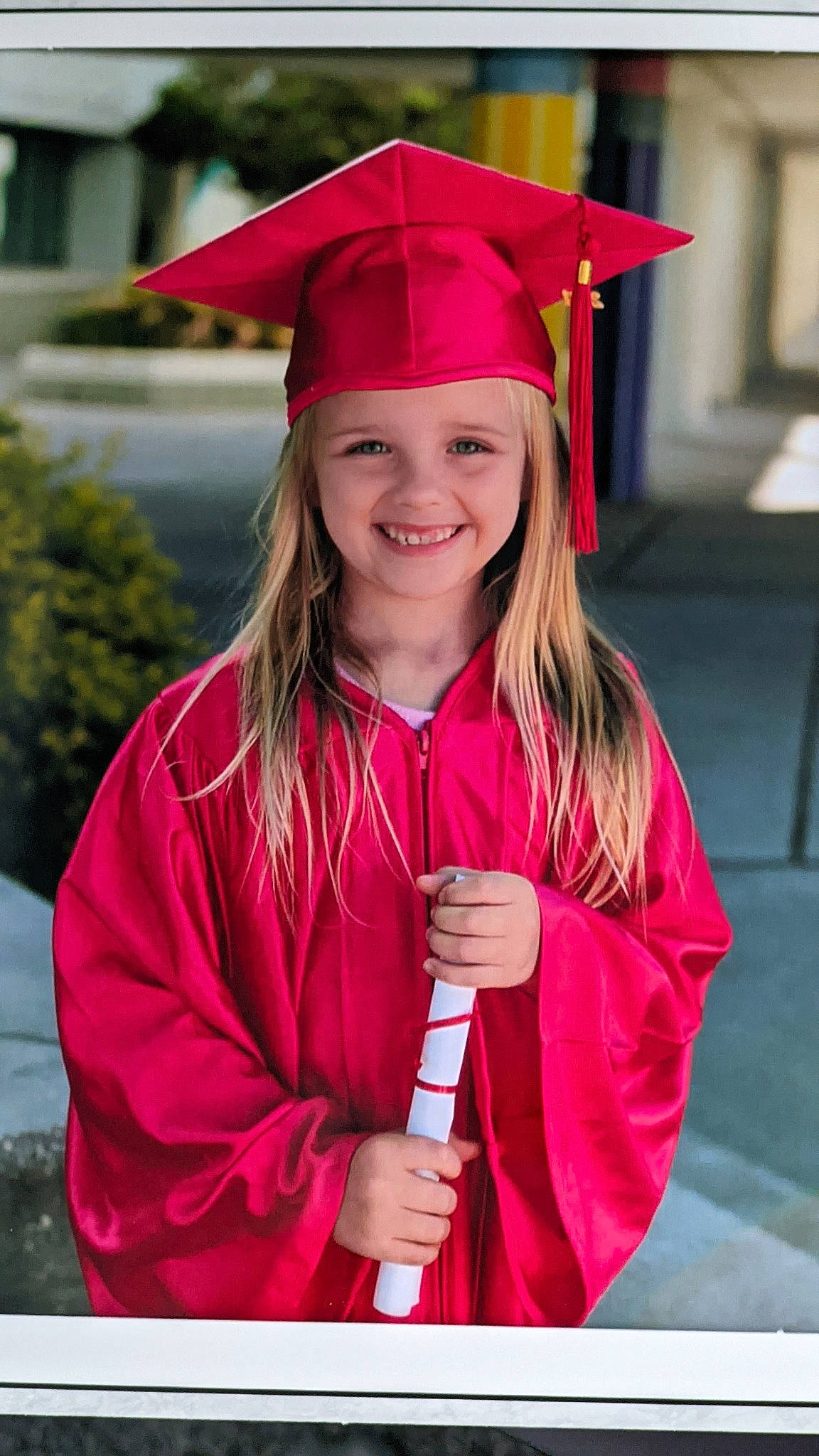 Riley joined the competition — help win amazing prizes! academic_dress, dress, eye, face, facial_expression, fashion, gesture, hair, happy, head, headgear, headwear, jacket, joy, mortarboard, outerwear, person, pink, purple, red