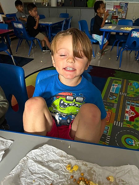 Cole joined the competition — help win amazing prizes! blue, chair, child, comfort_food, dish, education, event, fun, furniture, joy, leisure, person, play, recreation, room, sitting, smile, summer, t_shirt, table