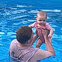adult, baby, back, blue, child, fun, head, holding, outdoor, person, pink_clothing, play, short_hair, skin, sleeveless_shirt, summer, swimming_pool, toddler, water, wet_clothing