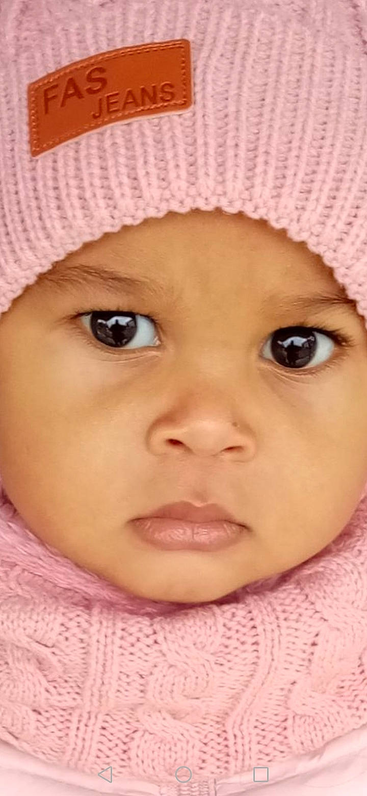 Kayla participe au concours pour gagner de l'argent avec cette photo : baby, cap, cheek, chin, ear, eye, eyebrow, eyelash, face, forehead, headwear, iris, lip, nose, organ, person, pink, product, skin, smile