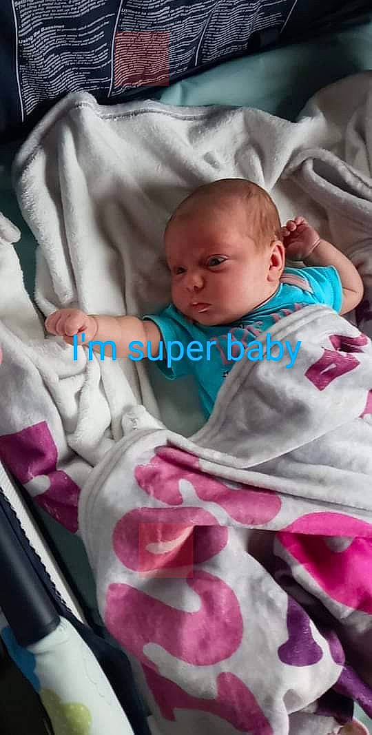 Delaney joined the competition — help win amazing prizes! baby, baby_carriage, baby_products, baby_sleeping, baby_toddler_clothing, bedding, cheek, child, comfort, linens, magenta, person, pink, product, room, sitting, skin, sleeve, snapshot, textile