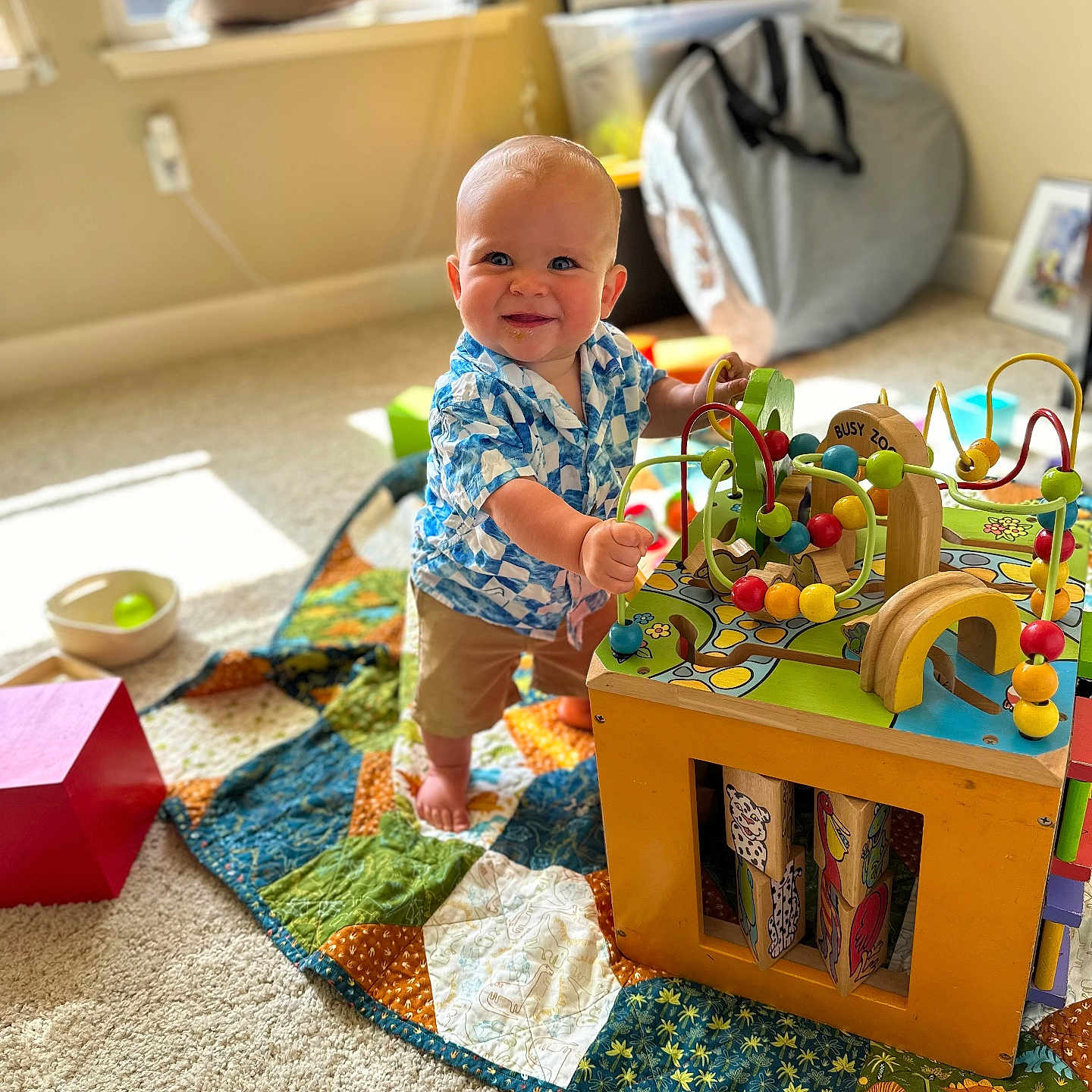 Grayson is registered to the contest to win money with this photo: accessories, architecture, baby, bag, building, clothing, face, furniture, handbag, head, homedecor, indoors, livingroom, person, photography, playarea, portrait, room, shorts, toy