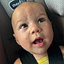 baby, child, car_seat, seatbelt, straps, face, expression, curious, indoors, person, head, skin, clothing, yellow, cute, infant, closeup, safety, car, seat