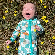 Archer joined the competition — help win amazing prizes! baby, infant, smiling, grass, yellow_flowers, dinosaur_onesie, outdoor, nature, sunlight, happy, child, lying_down, greenery, cute, joyful, one_person, grass_field, playful, spring, barefoot