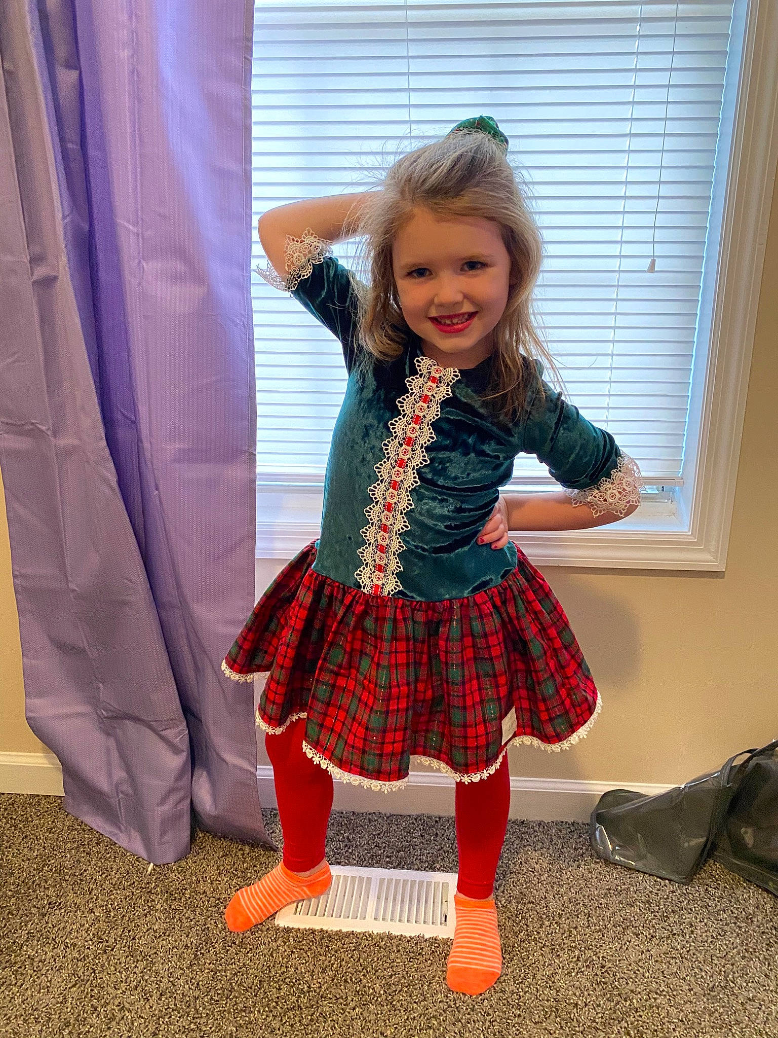 Addie is registered to the contest to win money with this photo: child, child_model, clothing, costume, design, dress, footwear, joy, pattern, person, plaid, shoe, smile, tartan, textile, tights, toddler