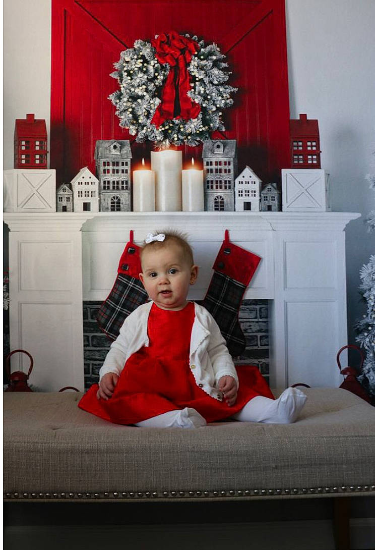 Kynzlee is registered to the contest to win money with this photo: baby, baby_toddler_clothing, christmas, christmas_eve, comfort, event, flooring, interior_design, lighting, ornament, person, picture_frame, rectangle, red, room, sitting, sleeve, toddler, white, window