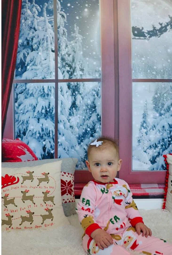 Kynzlee is registered to the contest to win money with this photo: baby, baby_toddler_clothing, christmas, christmas_decoration, christmas_eve, christmas_ornament, dress, event, flooring, holiday, ornament, pattern, person, room, sleeve, snow, textile, toddler, white, window