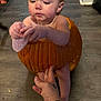 Stormie joined the competition — help win amazing prizes! toddler, child, pumpkin, hollowed_pumpkin, hand, floor, indoor, baby, autumn, seasonal, cute, person, skin, tattoo, support, curious, expression, orange, wood, home