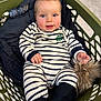 Martin participe au concours pour gagner de l'argent avec cette photo : baby, black_socks, blue_eyes, child, clothing, cute, fabric, face, floor, hand, happy, indoor, infant, laundry_basket, person, pom_pom, seat, smile, striped_clothing, toy