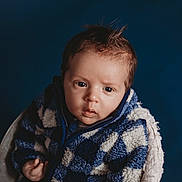 Brevon joined the competition — help win amazing prizes! baby, infant, child, portrait, close_up, blue_background, sherpa_jacket, cozy, warm_clothing, face, eyes, hair, expression, looking_at_camera, studio_lighting, seat, blanket, texture, cute, young