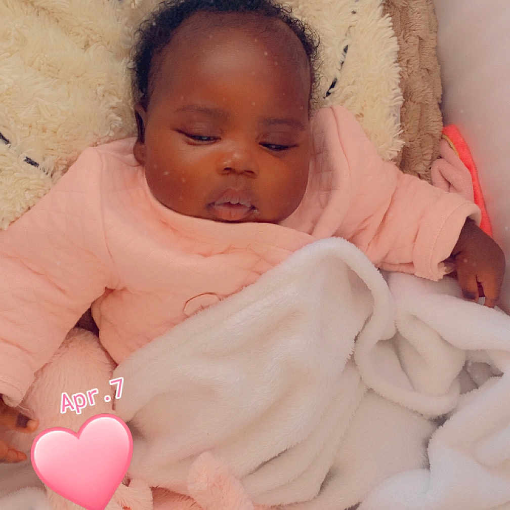 Zahra participe au concours pour gagner de l'argent avec cette photo : baby, sleeping, blanket, pink_clothing, cozy, infant, cute, heart_sticker, soft_texture, child, resting, indoors, portrait, wrapped, peaceful, adorable, newborn, warm, toddler, face