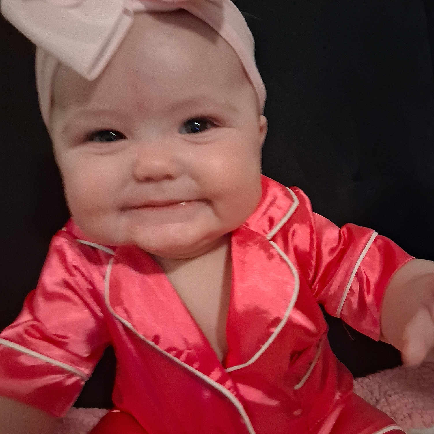 Addilynn joined the competition — help win amazing prizes! baby, child, smile, headband, bow, pajamas, red_clothing, infant, cute, portrait, face, chubby_cheeks, sitting, indoor, young_child, person, closeup, happy, fashion, apparel