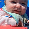 Addilynn is registered to the contest to win money with this photo: baby, smile, face, child, bib, clothing, seat, plastic, sunlight, shadow, cheeks, closeup, happy, infant, person, blue, red, outdoor, cute, young