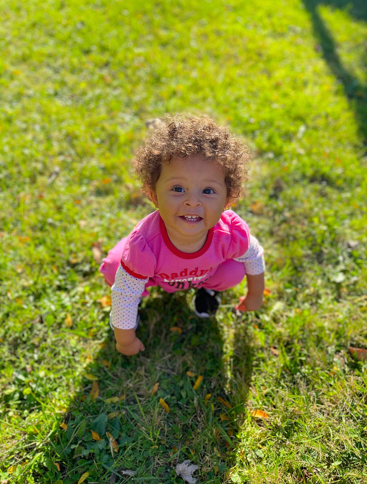 Khaniya is registered to the contest to win money with this photo: baby_toddler_clothing, child, face, field, grass, grass_family, grassland, groundcover, happy, joy, landscape, lawn, meadow, natural_environment, natural_landscape, people_in_nature, person, plant, prairie, rural_area