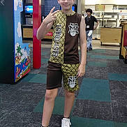 Keyson joined the competition — help win amazing prizes! arcade_machine, background_people, blue_tiles, boy, carpet, casual_clothing, child, floor, food_counter, indoor, peace_sign, person, restaurant, short_hair, shorts, sleeveless_shirt, smile, sneakers, standing, young