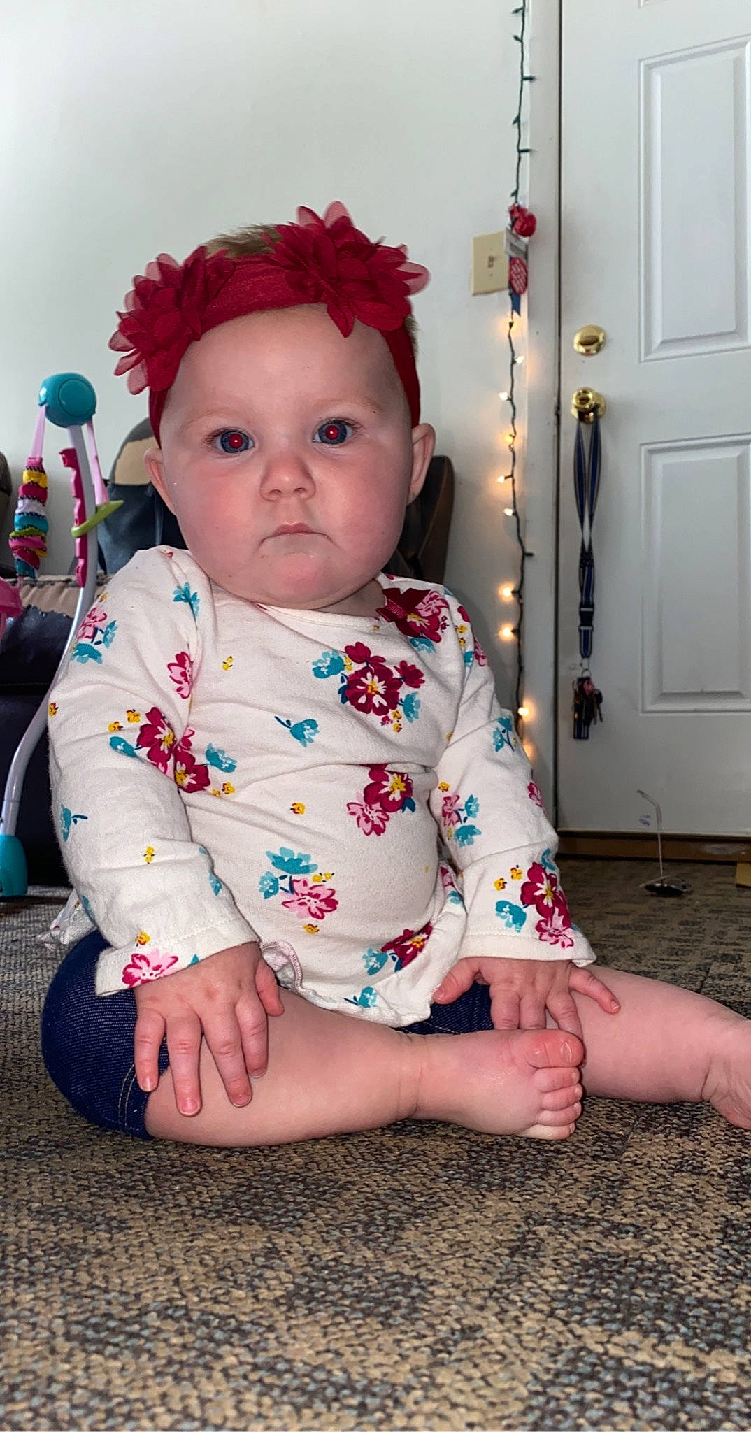 Brynnlee is registered to the contest to win money with this photo: baby, baby_toddler_clothing, cheek, child, dress, face, hair_accessory, head, headgear, headwear, leg, lip, pattern, person, pink, play, sitting, skin, sleeve, smile
