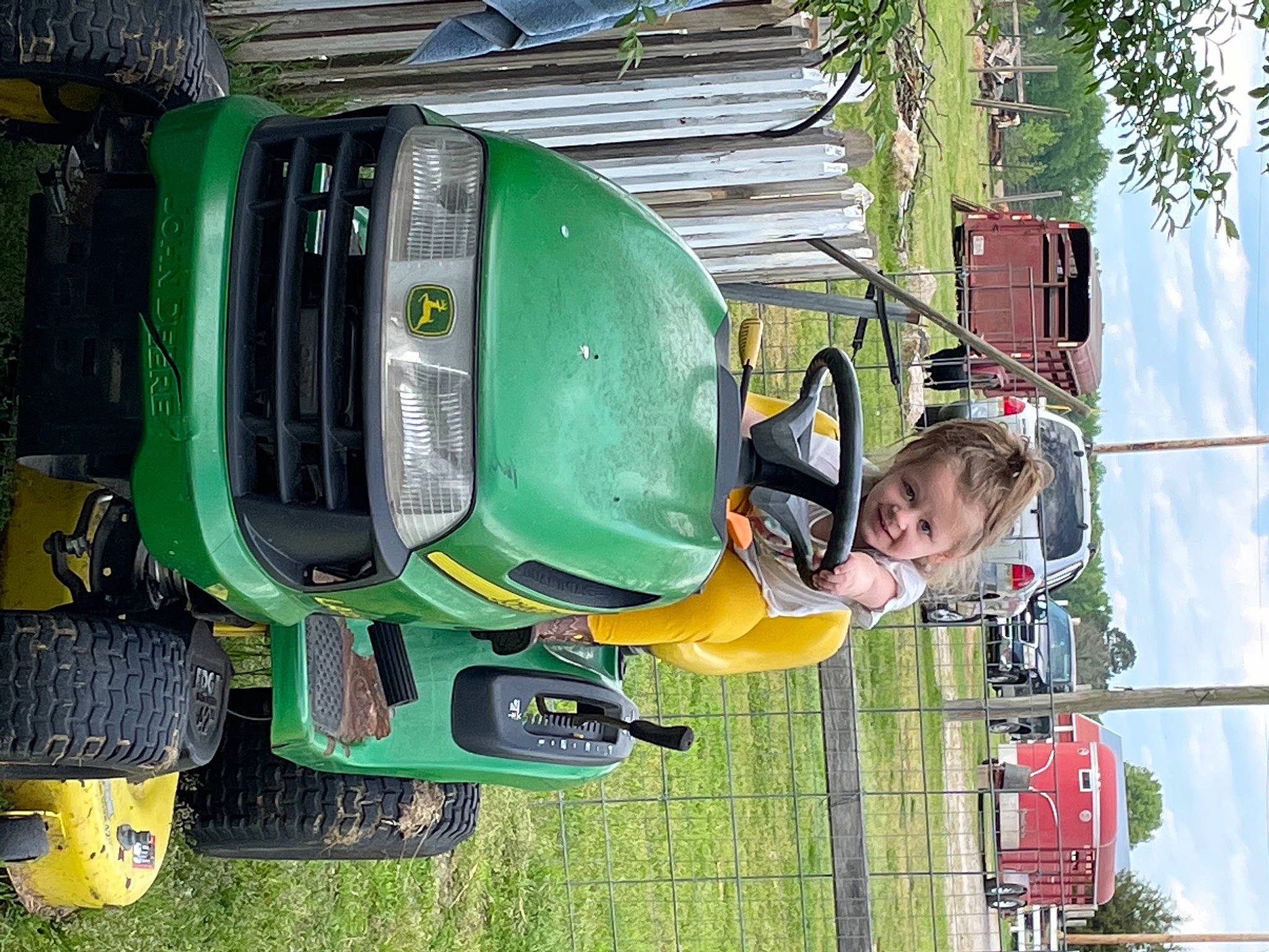 Gracelynn is registered to the contest to win money with this photo: auto_part, automotive_design, automotive_exterior, automotive_lighting, automotive_tire, automotive_wheel_system, bumper, car, fender, green, helmet, hood, motor_vehicle, person, sky, tire, toddler, tree, vehicle, wheel