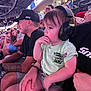 Kaizer joined the competition — help win amazing prizes! toddler, child, headphones, person, crowd, spectators, indoor, event, seated, adult, tattoo, cap, shorts, tshirt, hand, face, noise_cancelling_headphones, drinking_cup, light, stadium