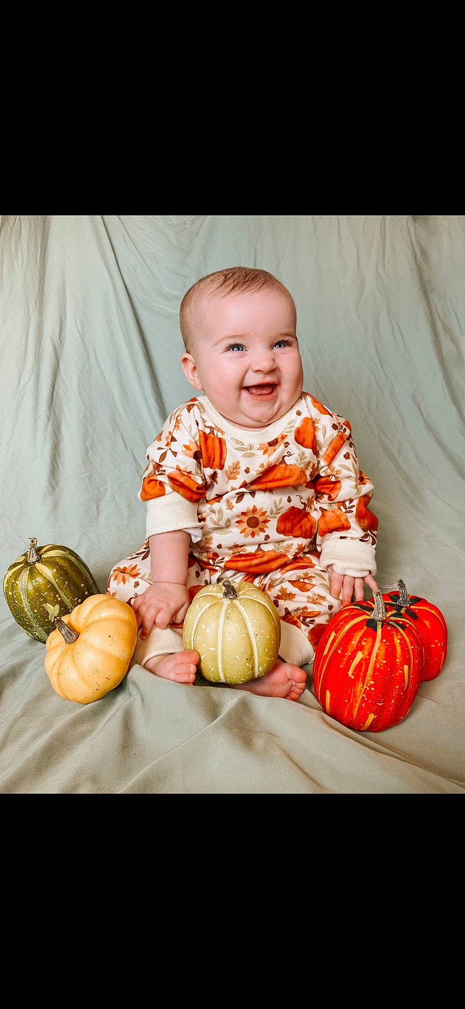 Aubrey is registered to the contest to win money with this photo: arm, baby_toddler_clothing, calabaza, clothing, dress, eye, face, facial_expression, flash_photography, happy, head, human_body, iris, joy, natural_foods, orange, person, plant, pumpkin, smile
