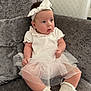 baby, child, infant, dress, tulle, headband, bow, socks, couch, sofa, furniture, indoor, portrait, cute, curious, person, seated, white, soft_lighting, plush