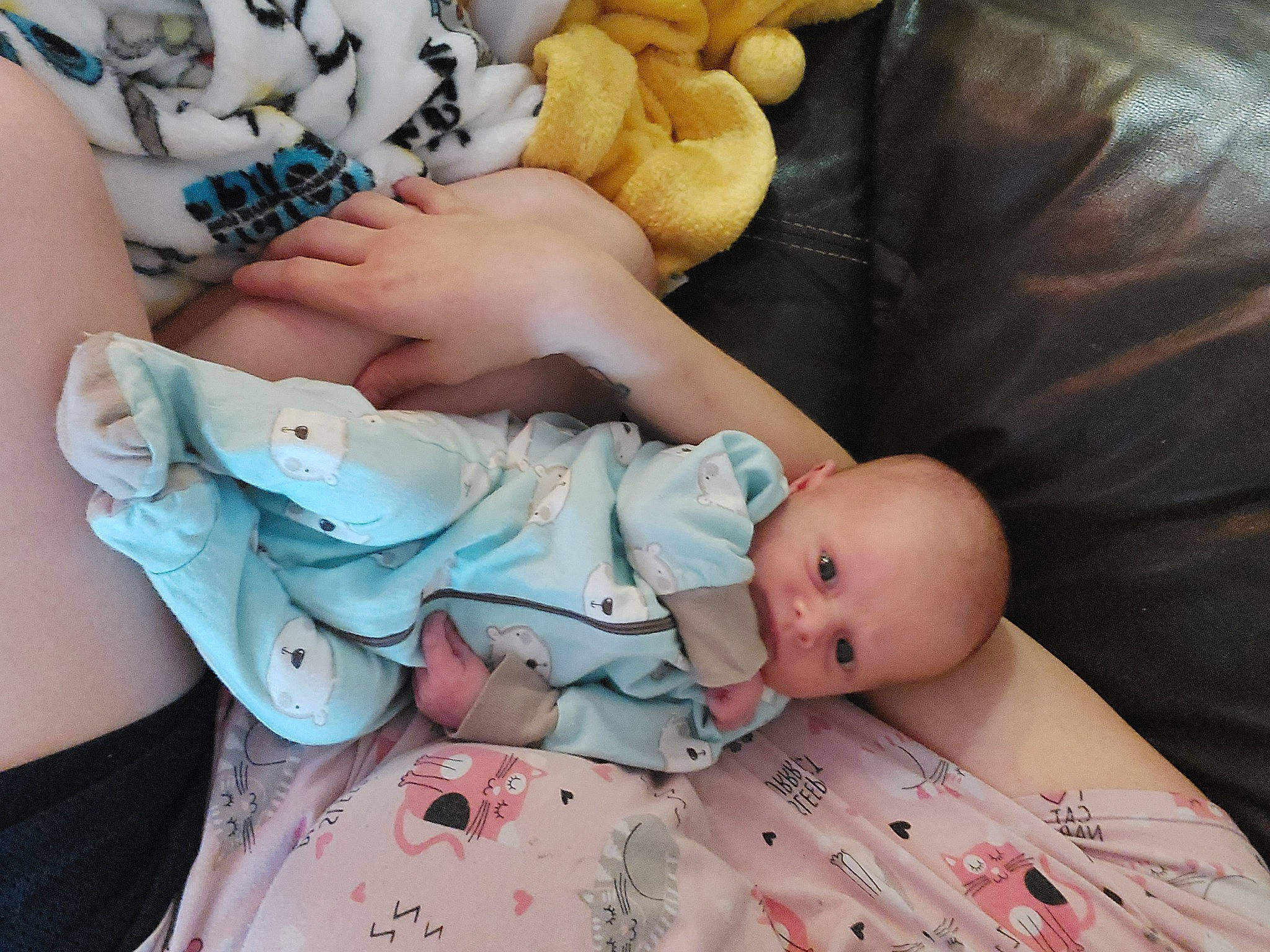 Evander is registered to the contest to win money with this photo: abdomen, baby, baby_products, baby_sleeping, baby_toddler_clothing, child, comfort, couch, finger, human_leg, linens, nail, pattern, person, sitting, skin, textile, thigh, toddler