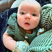 Arabella joined the competition — help win amazing prizes! baby, blanket, child, closeup, clothing, cozy, cute, expression, face, floral, green, indoors, infant, mittens, newborn, pattern, person, portrait, soft, striped