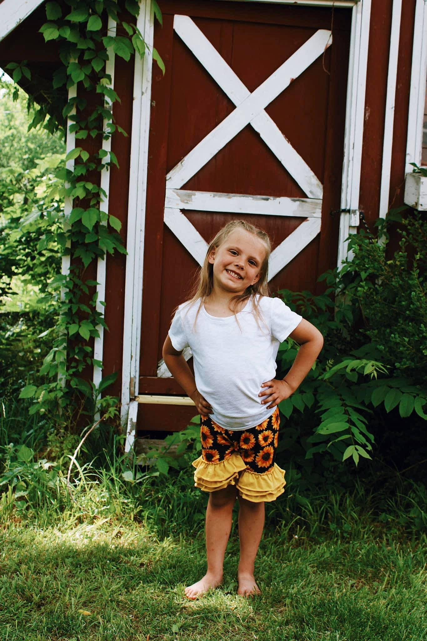 Izzy joined the competition — help win amazing prizes! barefoot, child, fun, garden, grass, happy, joy, leisure, magenta, pattern, people_in_nature, person, plant, sandal, sleeve, smile, standing, t_shirt, toddler, waist
