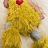 Jazara joined the competition — help win amazing prizes! baby, child, costume, yellow, fluffy, heart, curly_hair, bow, blanket, soft, cute, infant, lying_down, legs, feet, sock, portrait, indoors, person, smiling
