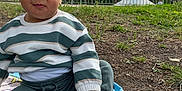 Naïm participe au concours pour gagner de l'argent avec cette photo : baby, blanket, casual_clothing, child, curious, daylight, fence, grass, green_pants, ground, nature, outdoor, park, person, shoes, sitting, striped_sweater, toddler, trees, young_child