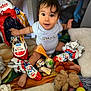 baby, blanket, child, colorful, cute, expression, foot, hand, indoor, kinder_surprise, mickey_mouse, onesie, playpen, playtime, sitting, soft_toys, stuffed_animal, surprised, toy, wrapped_candy